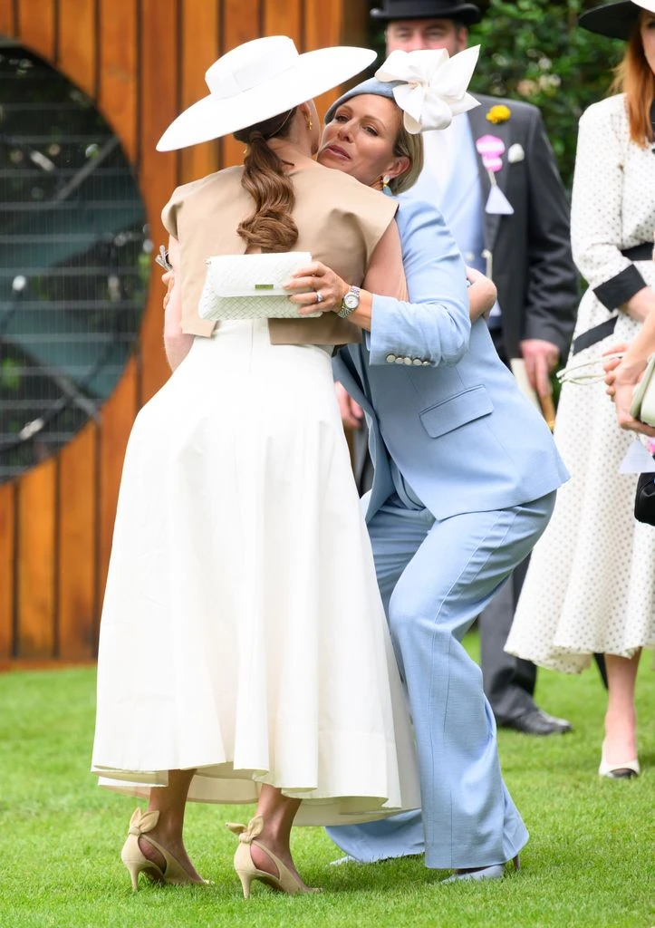 zara tindall and princess eugenie sharing hug at ascot